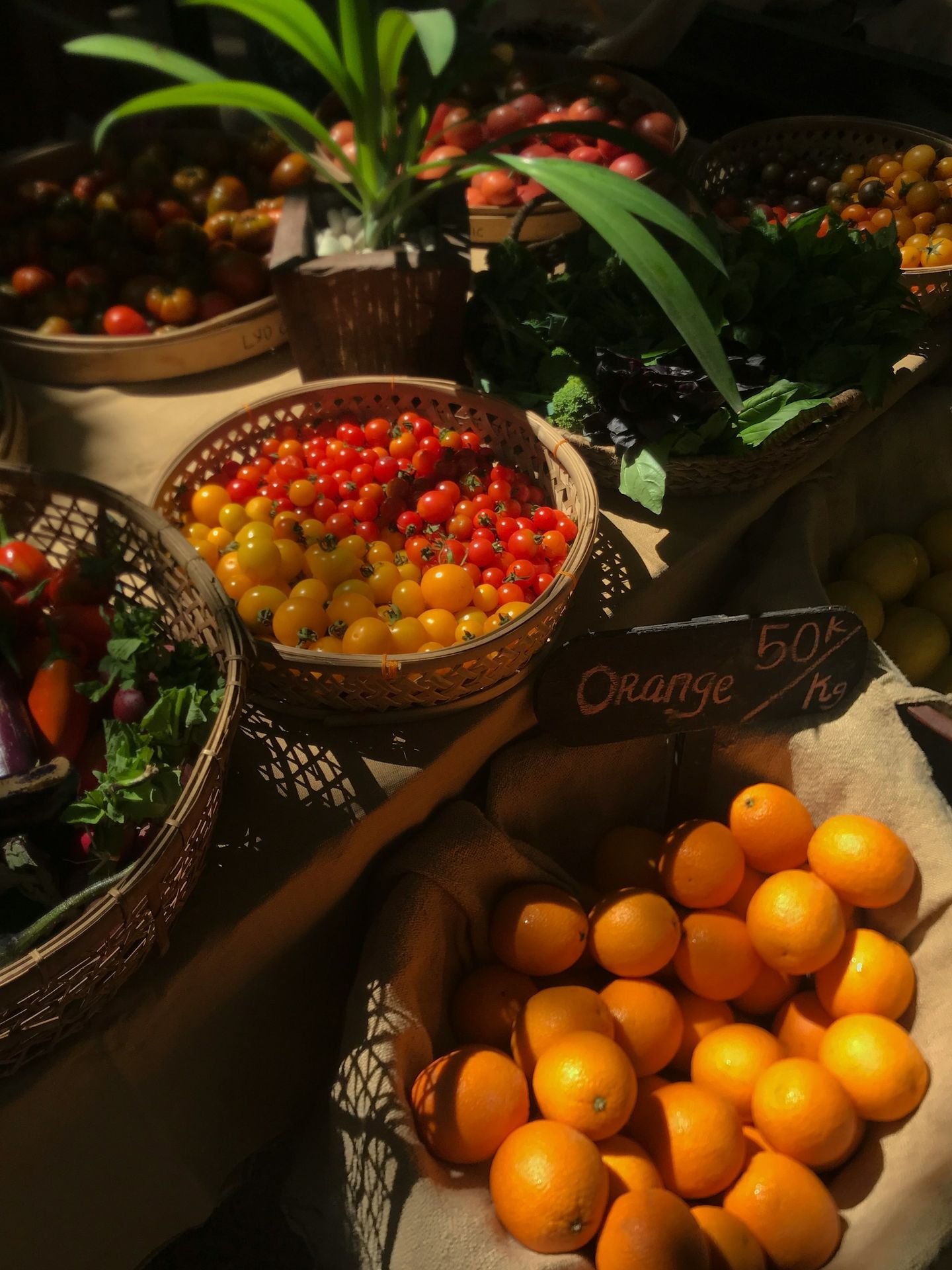 a table topped with baskets filled with lots of fruit